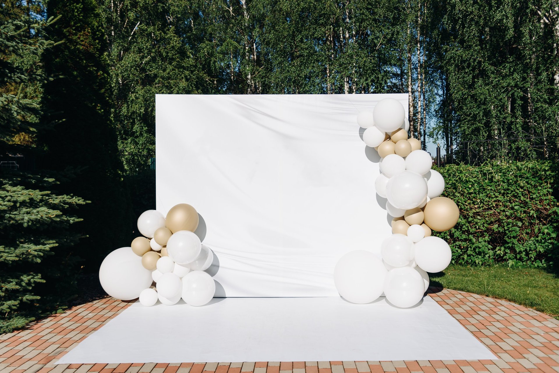 Beautiful outdoor celebration setup with white and gold balloons